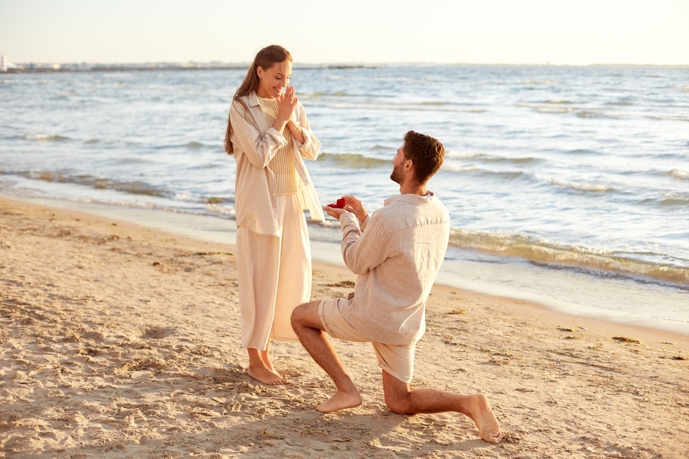 Man proposing to woman on beach